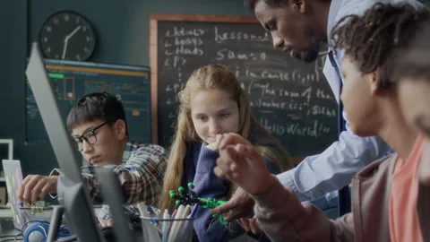 Teacher Helping Students during Robotics Lesson in Class Stock Footage 284437981