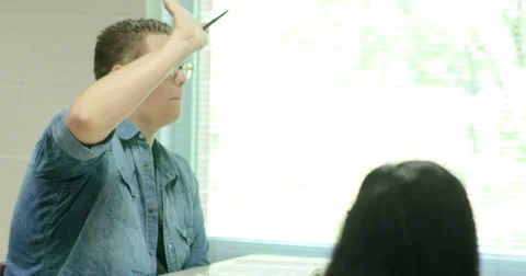 Teacher helping students with their assignments. Ultra HD 4K Video stock 44405541
