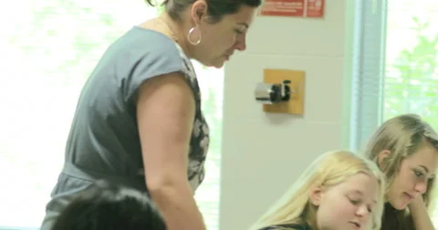 Teacher helping students with their assignments. Ultra HD 4K Stock Footage 44873897