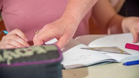 Teacher is helping their students with maths Video stock 77676990