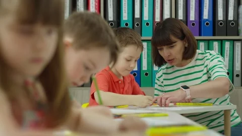 The teacher helps the student to correctly complete the tasks in the lesson Stock Footage 248641939