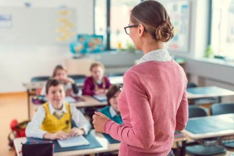 Teacher with her students in class at elementary school Stock Photos