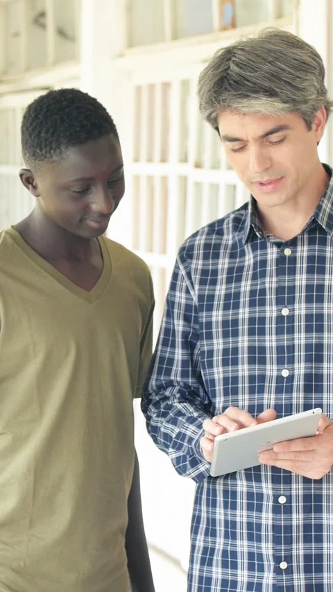 Teacher in the high school hallway. Vertical Video Stock Footage 273787525