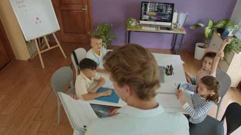 Teacher Holding Folder with Lesson Plan, Explaining Topic to Kids at IT Class Stock Footage 280539360