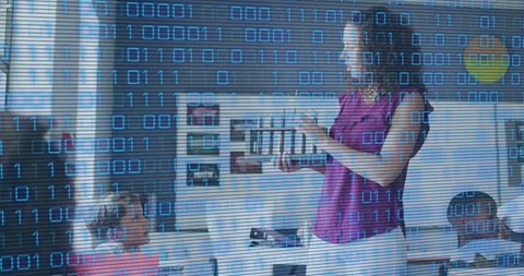 Teacher holding tablet and demonstrating digital lesson in classroom, binary Stock Footage 331214447