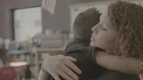 Teacher hugging student Stock Footage 62828694