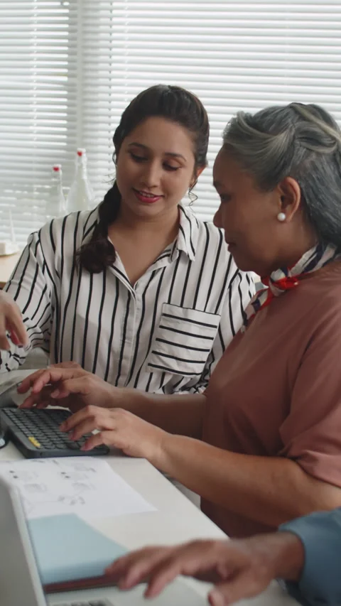 Teacher Instructing Aged Woman at Computer Class Stock Footage 263796977