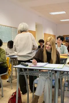 Teacher instructing diverse high school students in classroom Stock Photos