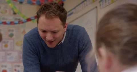 Teacher interacting with children in classroom Stock Footage 58573038
