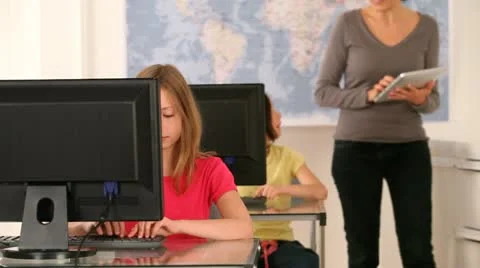 Teacher with kids in computer classroom Stock Footage
