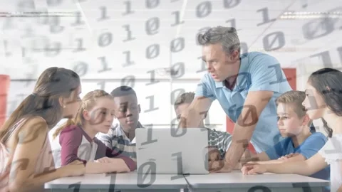 Teacher leaning over laptop with students gathering, pointing and causing binary Stock Footage 334338002