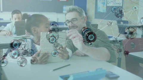 Teacher leaning over tablet, guiding girl tapping screen in school with animated Stockbeeldmateriaal 329812778