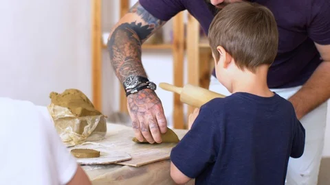 Teacher is learning little boy how to sculpt from clay. Stock Footage 109397328