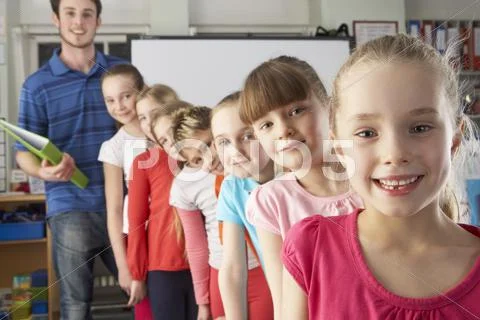 Teacher with line up of children in class Stock Photos