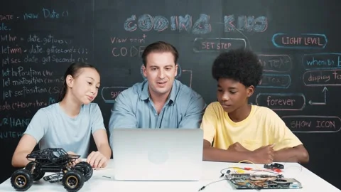 Teacher looking at laptop while teaching about engineering code. Edification Stock Footage 265613128