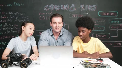 Teacher looking at laptop while teaching about engineering code. Edification Stock Footage 273735454
