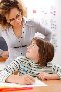 Teacher looking at student Stock Photos