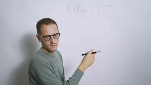 Teacher man explains Python frameworks near white blackboard Stock Footage 162308180