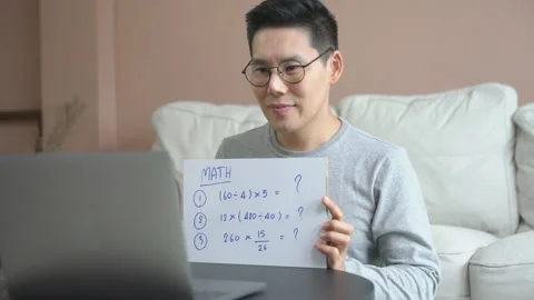 Teacher man use laptop working from home teach online video conference math 動画素材 133629342
