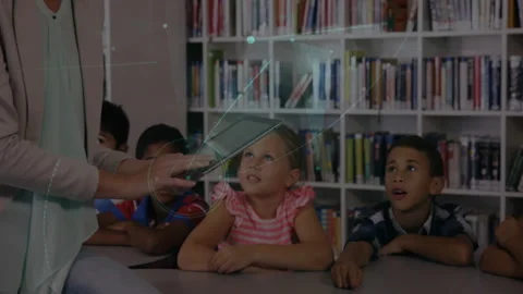 Teacher opening tablet and tapping screen to engage students with expanding Video stock 312280366