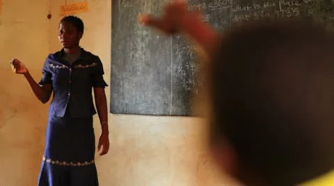Teacher picking a child to answer a question in a Kenyan classroom. Video stock 8977784