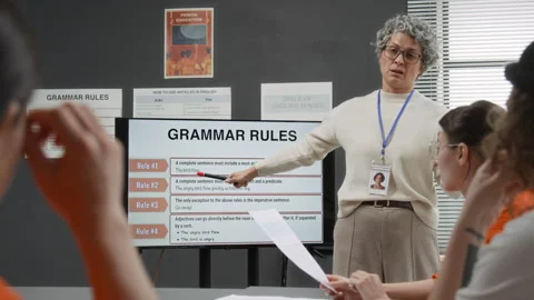 Teacher Pointing at Digital Screen and Explaining English Grammar Rules Stock Footage 329000601