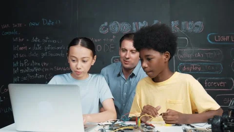 Teacher pointing at laptop while teaching about engineering code. Edification Stock Footage 266175630