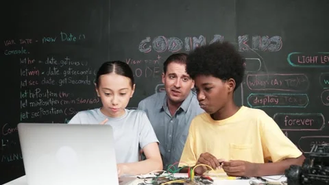 Teacher pointing at laptop while teaching about engineering code. Edification Stock Footage 273102137