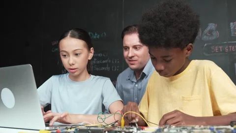 Teacher pointing at laptop while teaching about engineering code. Edification Stock Footage 277156812