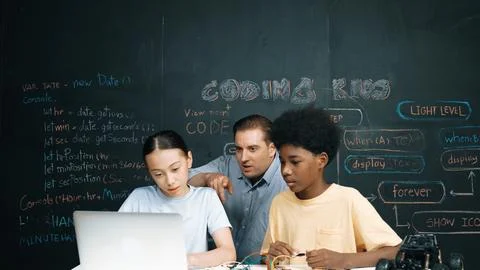 Teacher pointing at laptop while teaching about engineering code. Edification. Stock-Fotos