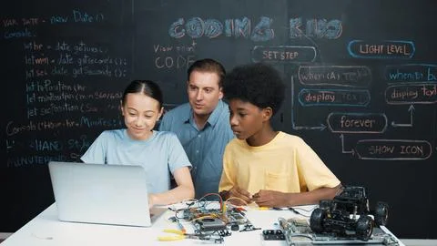 Teacher pointing at laptop while teaching about engineering code. Edification. Stockfoto's