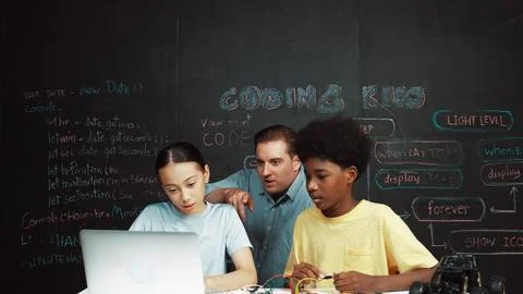 Teacher pointing at laptop while teaching about engineering code. Edification. 스톡 사진