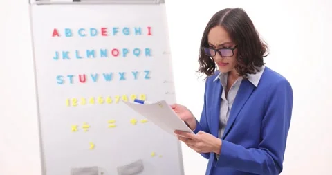 Teacher reviews student work expressing disappointment Stock Footage 294310199