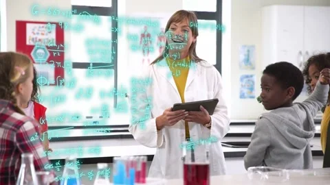 Teacher in science lab tapping tablet and engaging class, pupils raising hands, Stock Footage 334372558