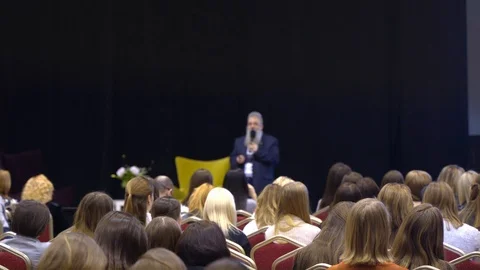 Teacher, scientist lectures in front of a large female audience in a large hall Stock-Footage 111160370