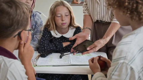 Teacher Showing Digital Device to School Children in Classroom Stock Footage 345226693