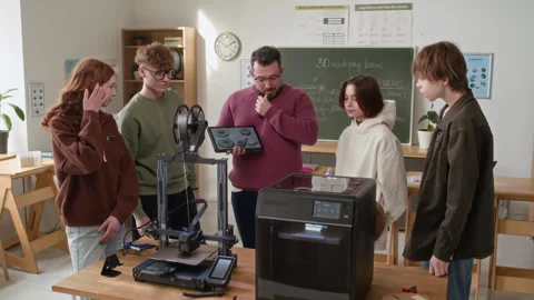 Teacher Showing Students 3D Models of Gears at Table with 3D Printers Stock Footage 335697576