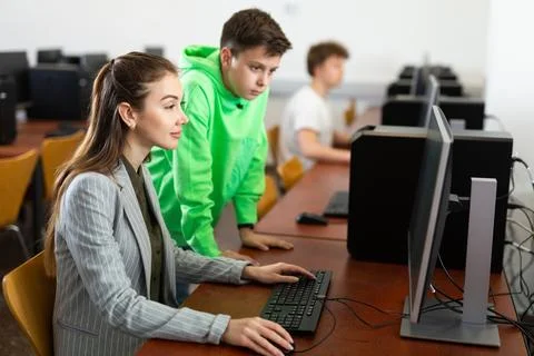 Teacher shows the student how to solve the problem on computer Stock Photos