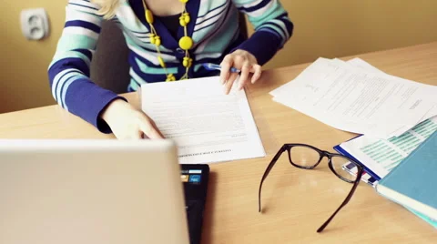 Teacher sitting at the desk and checking exams, steadycam shot 스톡 동영상 61190679