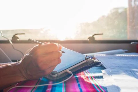 Teacher smart working from a van. Focus on pen. Woman hand close up using tab Stock Photos