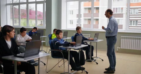 Teacher Speaking In Computer-Based Class, Diverse School Boys Learning In Coding Stock Footage 280174809
