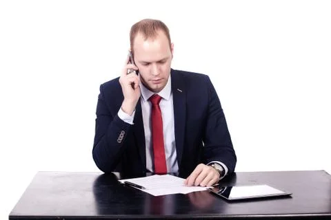 Teacher is speaking by phone while working with documents Fotos de archivo
