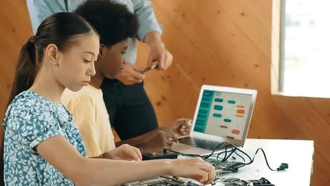 Teacher standing while explain coding and robotic construction. Edification. 写真素材