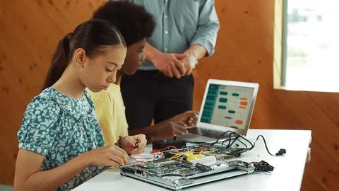 Teacher standing while explain coding and robotic construction. Edification. Stock Photos