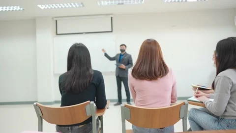 The teacher stands in front of the classroom teaching students in the classro 動画素材 147957140