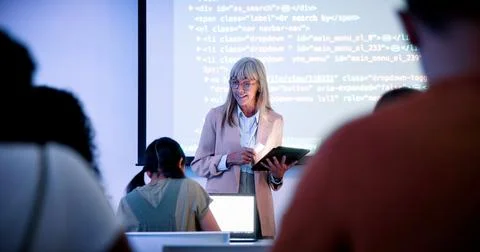 Teacher, students and presentation with tablet in classroom, programming co.. 库存照片