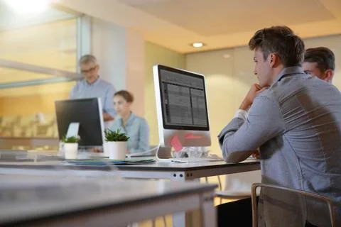 Teacher with students in apprenticeship attending computing class Stock Photos
