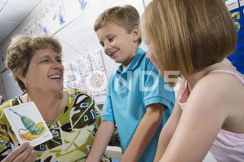 Teacher With Students In Classroom Stock Photos