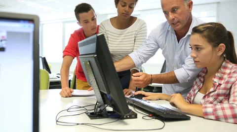 Teacher with students in computing class Stock Footage