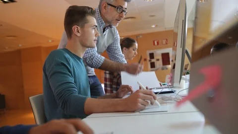 Teacher with students in computing class Stock Footage 86463896